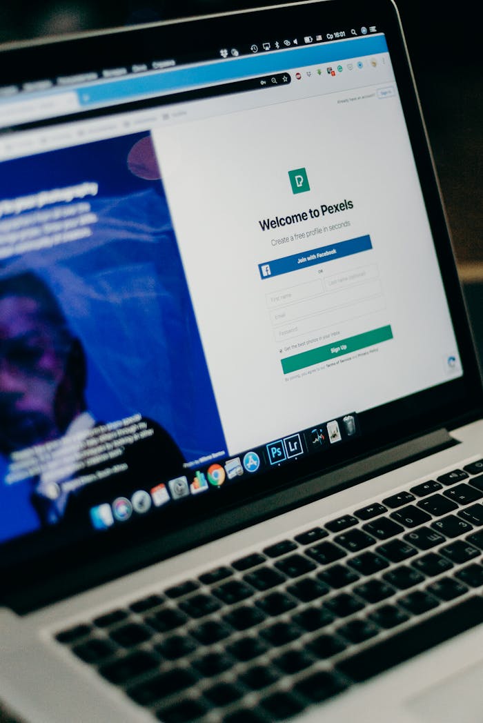 about-01 Close-up view of a laptop displaying a sign-up page for an online platform.